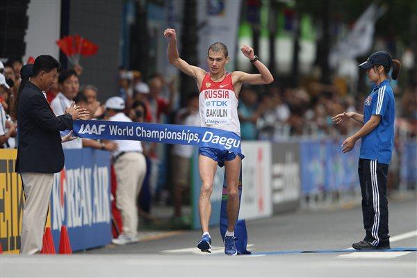 Sergey Bakulin of Russia crosses the finishing line to win gold in the Men's 50 Kilometres Race Walk Final (Getty Images)