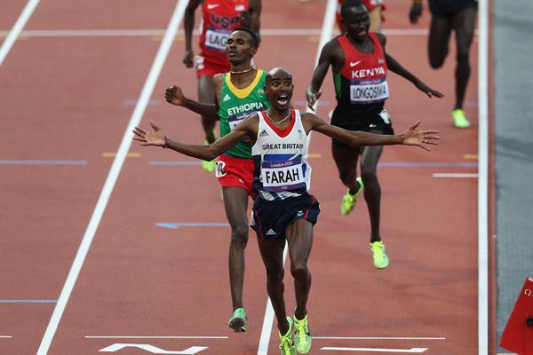 Mo Farah of Great Britain crosses the finish line to win gold ahead of Dejen Gebremeskel of Ethiopia and Thomas Pkemei Longosiwa of Kenya in the Men's 5000m Final on Day 15 of the London 2012 Olympic Games  on August 11, 2012 (Getty Images)
