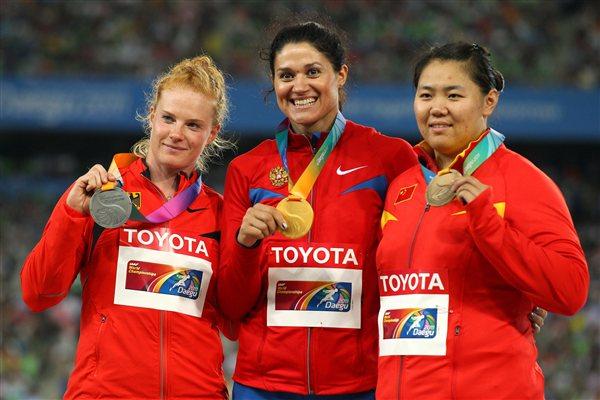 Tatyana Lysenko of Russia celebrates with her gold medal, Betty Heidler of Germany her silver and Wenxiu Zhang of China her bronze in the medal ceremony for the women's hammer throw final (Getty Images)