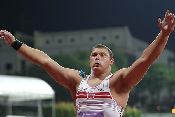 Krzysztof Brzozowski of Poland celebrates winning the boys shot put final at the Youth Olympic Games in Singapore (XINHUA/ SYOGOC-Pool/ Liao Yujie)