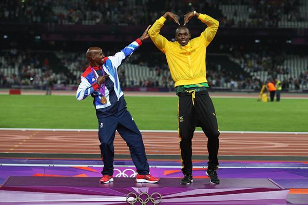 Gold medalist Mo Farah of Great Britain (L) and Usain Bolt of Jamaica have fun on the podium after the medal ceremonies - London 2012 Olympic Games on August 11 2012 (Getty Images)