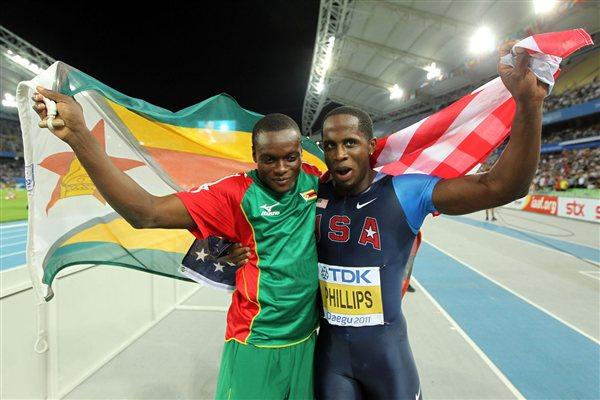  Gold medalist Dwight Phillips of the United States and bronze medalist Ngonidzashe Makusha of Zimbabwe celebrate after the men's long jump final (Getty Images)