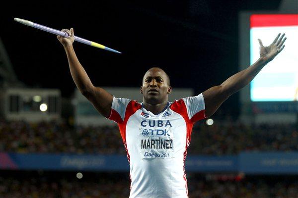 Guillermo Martinez of Cuba motivates the crowd during the men's javelin throw final (Getty Images)