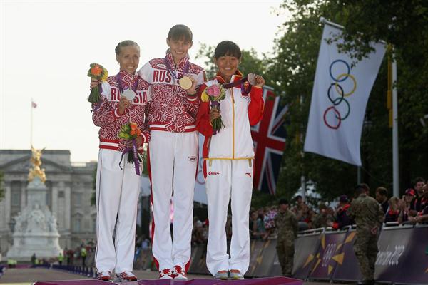 Gold medalist Elena Lashmanova of Russia, silver medalist Olga Kaniskina of Russia and bronze medalist Shenjie Qieyang of China attend the medal ceremony of the Women's 20km Walk on Day 15 of the London 2012 Olympic Games on the streets of London on August 11, 2012  (Getty Images)