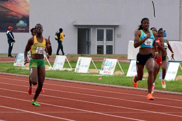 Shaunae Miller of Bahamas (right) on her way to victory in the women's under 20 200m at the 2013 Carifta Games (Anthony Foster)
