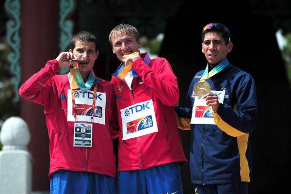Gold medalist Valeriy Borchin of Russia (c) celebrates with silver medalist Vladimir Kanaykin (l) and Luis Fernando Lopez of Columbia after the mens 20k walk during day two (Getty Images)