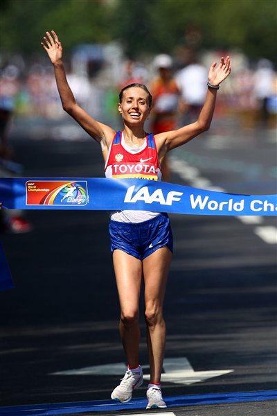 Gold medalist Olga Kaniskina of Russia celebrates as she crosses the finish line during the women's 20km race walk during day five  (Getty Images)