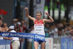 Sergey Bakulin of Russia crosses the finishing line to win gold in the Men's 50 Kilometres Race Walk Final (Getty Images)