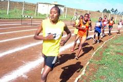Nelly Chebet (in yellow) leads the 5000m at the Kenyan national high schools championships in Eldoret. She won in 16:30.7 (David Macharia)