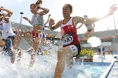 Athletes attempt to clear the water jump during the Women's 3000 metre Steepechase qualification heat on the day one of the 14th IAAF World Junior Championships in Barcelona (Getty Images)