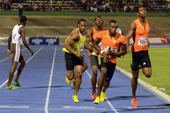 Yohan Blake (yellow vest) collects the baton behind Edino Steele at the 2013 Gibson Relays  (Anthony Foster)