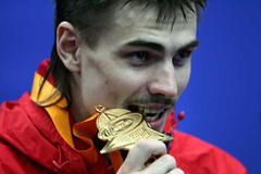 Yaroslav Rybakov of Russia bites his gold medal after winning the High Jump final (Getty Images)