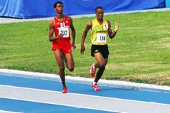 Eventual winner Trinidad & Tobago’s Gavyn Nero (Red kit - left) battles with Jamaica’s Kemoy Campbell in the 1500m - 2009 CARIFTA Games (Jed Charles)