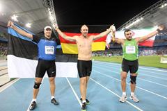 Robert Harting of Germany celebrates victory in the Men's discus final with Gerd Kanter of Estonia (L) and Ehsan Hadadi of Iran (R) during day four  (Getty Images)
