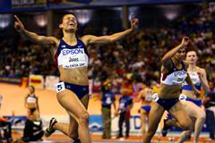 Lolo Jones celebrates as she crosses the finish line in the women's 60m hurdles (Getty Images)