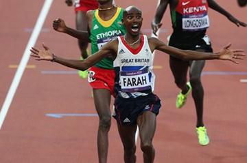 Mo Farah of Great Britain crosses the finish line to win gold ahead of Dejen Gebremeskel of Ethiopia and Thomas Pkemei Longosiwa of Kenya in the Men's 5000m Final on Day 15 of the London 2012 Olympic Games on August 11, 2012 (Getty Images)