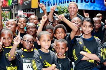 Dan O'Brien with young fans in New York City's Times Square during a '100 Kids - 100 metres - 100 years' relay event to mark the Centenary year of the IAAF, at which his inclusion into the IAAF Hall of Fame was announced. (Victah Sailer)