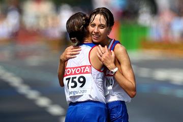 Gold medalist Olga Kaniskina (L) of Russia celebrates with bronze medalist Anisya Kirdyapkina of Russia after crossing the finish line during the women's 20km Race Walk (Getty Images)