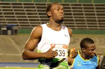 Usain Bolt easing through the first round of the 100m at the Jamaican Trials in Kingston (Anthony Foster)