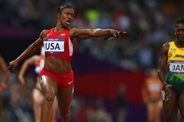 Carmelita Jeter of the United States celebrates winning gold ahead of Kerron Stewart of Jamaica and set a new World Record in the Women's 4 x 100m Relay Final of the London 2012 Olympic Games on 10 August 2012 (Getty Images)