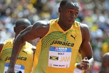 Usain Bolt takes the baton at Penn (Kirby Lee)