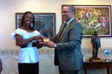 Veronica Campbell Brown presented with a gold coin recognising her efforts at the Beijing Olympics