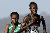 Tirunesh Dibaba (ETH) follows Isabella Ochichi (KEN) - 2005 World Cross Country (Getty Images)
