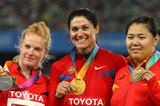 Tatyana Lysenko of Russia celebrates with her gold medal, Betty Heidler of Germany her silver and Wenxiu Zhang of China her bronze in the medal ceremony for the women's hammer throw final  (Getty Images)