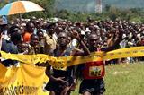 Boniface Kiprop and Moses Kipsiro both salute the win - Kiprop was declared the winner of the Ugandan XC (Daniel Senfuma)