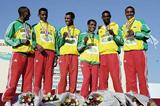 A smiling Bekele with short race gold medal team members (Getty Images)