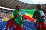 (L-R) Ethiopia's Kenenisa Bekele does his lap of honour after winning the gold medal in the men's 5000m at the 12th IAAF World Championships in Athletics (Getty Images)