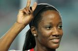 Kelly-Ann Baptiste of Trinidad and Tobago celebrates after finishing third in the women's 100 metres final  (Getty Images)