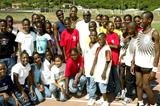 IAAF President Lamine Diack with some of the children at the IAAF Training Clinic in Kingston (IAAF)